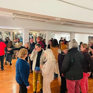 Visitors gathered at a community gallery opening